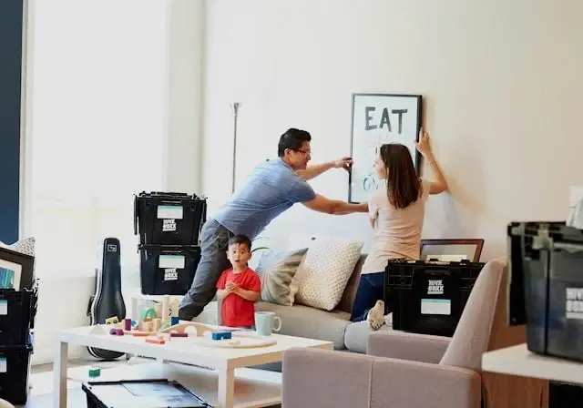A family unpacking boxes in their new living room